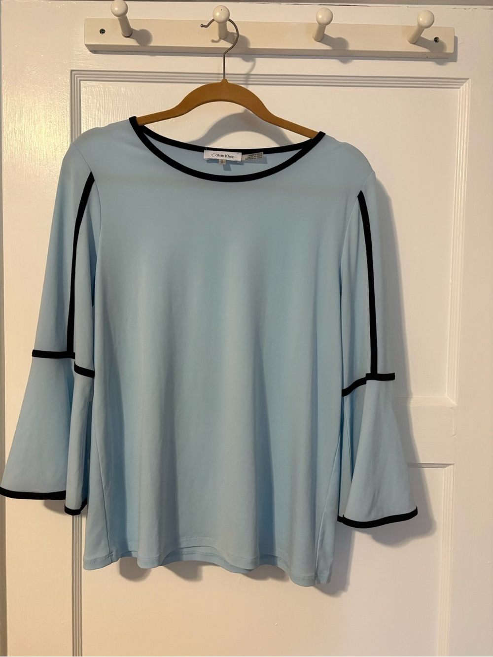 Calvin Klein light blue blouse featuring black trim and bell sleeves